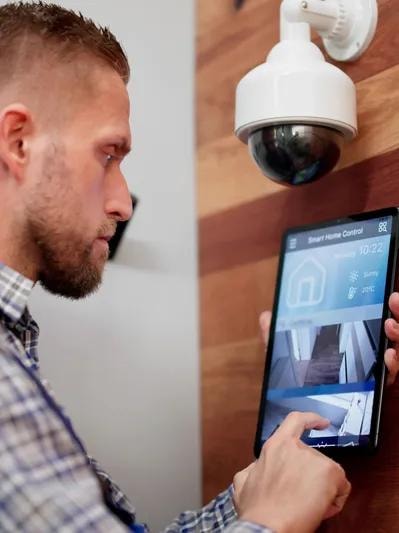 Man using smart home control app with security camera